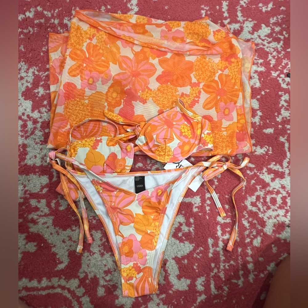 pink and orange floral printed bathing suit set with matching sarong